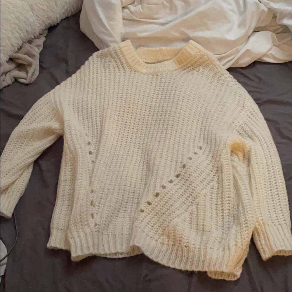 large cream colored sweater but could fit an XL